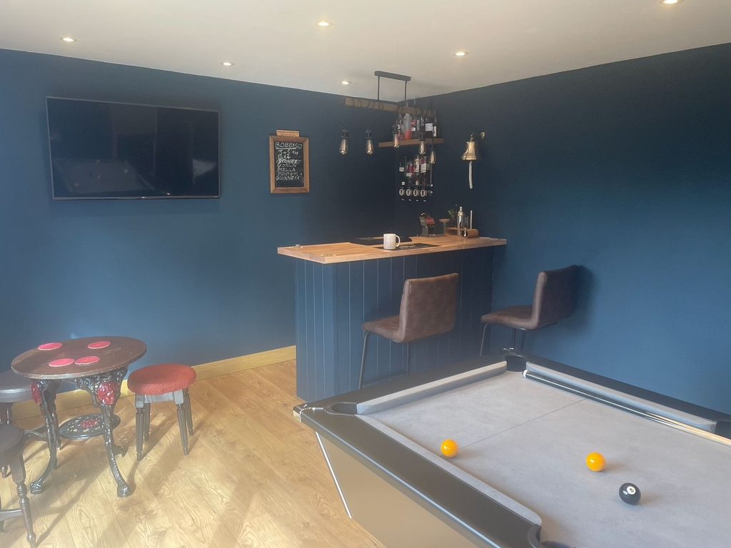 Garden games room with pool table and seating area